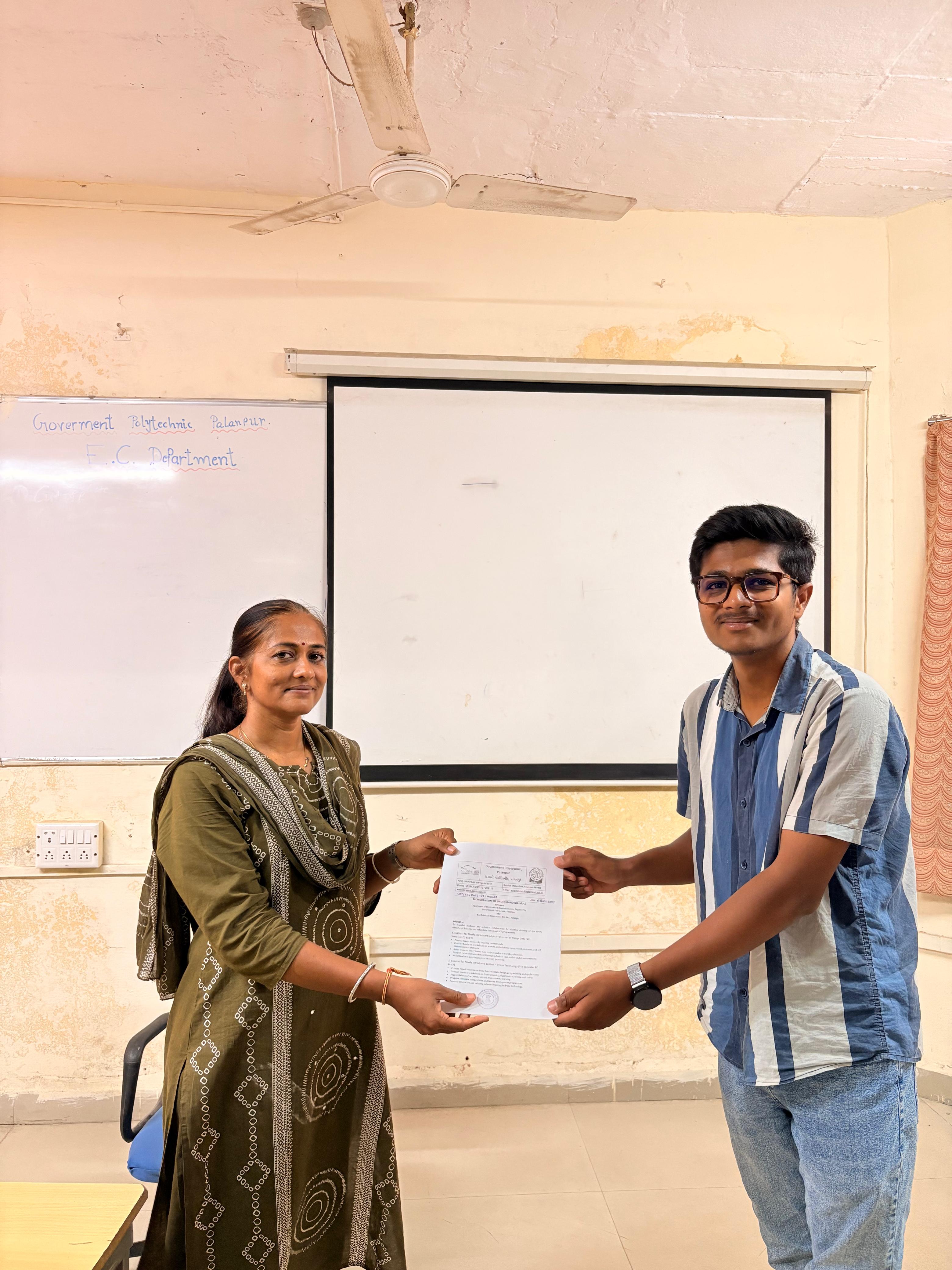 Mr. Rishabh Prajapati, Co-Founder, BeeRobokids Innovations, exchanging the signed 2026-27 MoU with EC Department faculty